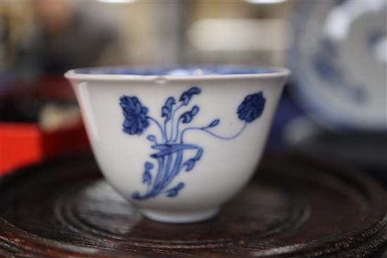 An 18th century Chinese blue and white tea bowl and saucer, and a similar bowl and two hardwood stands